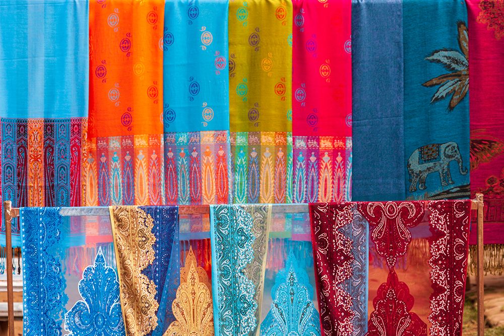 Wall Art Painting id:550577, Name: Laos- Luang Prabang. Colorful textiles- possibly scarves- for sale., Artist: Haseltine, Tom